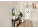 Inviting entryway with a decorative table, mirror, and stylish accents, offering a warm welcome to the home at 30238 N Ocotillo Dr, Florence, AZ 85132