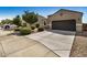 Charming single-story home featuring a two-car garage, long driveway, and manicured landscaping at 30238 N Ocotillo Dr, Florence, AZ 85132