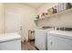 Functional laundry room with washer, dryer, and ample storage space for supplies at 30238 N Ocotillo Dr, Florence, AZ 85132