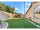 Spacious backyard featuring manicured lawn, stepping stones, mature trees, and desert landscaping at 3295 S Ambrosia Dr, Chandler, AZ 85248