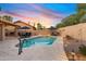 Desert backyard featuring a swimming pool, lounge chairs, outdoor dining and manicured landscaping at 3295 S Ambrosia Dr, Chandler, AZ 85248
