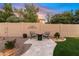 Cozy backyard patio featuring comfortable seating, a stylish chessboard, and manicured lawn space at 3295 S Ambrosia Dr, Chandler, AZ 85248