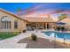 Backyard with manicured landscaping, swimming pool, and inviting patio furniture under the covered patio at 3295 S Ambrosia Dr, Chandler, AZ 85248