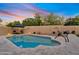 Backyard with pool, lounge chairs, patio seating, and desert landscaping at 3295 S Ambrosia Dr, Chandler, AZ 85248