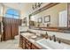 Elegant bathroom with dual sinks, granite countertops, and a decorative mirror at 3295 S Ambrosia Dr, Chandler, AZ 85248