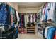 Well-organized walk-in closet with ample hanging space, shelving, and shoe storage solutions at 3295 S Ambrosia Dr, Chandler, AZ 85248