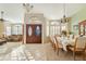 Bright dining room with elegant chandelier, carpet, and arched windows with wood shutters at 3295 S Ambrosia Dr, Chandler, AZ 85248
