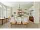 Bright dining room with elegant chandelier, carpet, and arched windows with wood shutters at 3295 S Ambrosia Dr, Chandler, AZ 85248