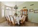 Bright dining room with elegant chandelier, carpet, and arched windows with wood shutters at 3295 S Ambrosia Dr, Chandler, AZ 85248
