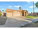 Charming single-story home featuring a three-car garage, desert landscaping, and a tile roof at 3295 S Ambrosia Dr, Chandler, AZ 85248