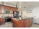 Kitchen with granite countertops, dark wood cabinetry, stainless appliances, and a kitchen island at 3295 S Ambrosia Dr, Chandler, AZ 85248