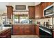 Updated kitchen with granite countertops, dark wood cabinetry, and a view to the backyard at 3295 S Ambrosia Dr, Chandler, AZ 85248