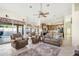 Open-concept living room with plush seating, neutral color palette, and seamless access to outdoor pool and kitchen at 3295 S Ambrosia Dr, Chandler, AZ 85248