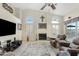 Bright living room with high ceilings, large windows, a fireplace, and stylish media center for modern comfort at 3295 S Ambrosia Dr, Chandler, AZ 85248