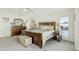 Comfortable main bedroom with a wooden bed, neutral decor, and natural light at 3295 S Ambrosia Dr, Chandler, AZ 85248