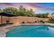 Beautiful backyard pool area with a lounge chairs and manicured landscaping at sunset at 3295 S Ambrosia Dr, Chandler, AZ 85248