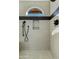 Contemporary shower featuring sleek, light tile work and a half-moon window for natural light at 3295 S Ambrosia Dr, Chandler, AZ 85248