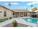 Inviting pool area with travertine patio, shaded seating, mature landscaping, for relaxing in a private backyard retreat at 3295 S Ambrosia Dr, Chandler, AZ 85248