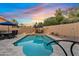 Calming evening view of pool with travertine patio, with cozy seating areas for luxurious outdoor living and dining at 3295 S Ambrosia Dr, Chandler, AZ 85248