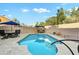 Sparkling swimming pool surrounded by travertine patio, and comfortable seating areas for ultimate relaxation and enjoyment at 3295 S Ambrosia Dr, Chandler, AZ 85248