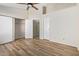 A bedroom with wood-look floors, ceiling fan, two closets and two doors at 3416 W Julie Dr # 4, Phoenix, AZ 85027
