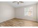 Bright bedroom featuring wood-look floors, ceiling fan, and a window at 3416 W Julie Dr # 4, Phoenix, AZ 85027