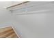 A clean closet with a hanging rod and wood-look floors provides convenient storage at 3416 W Julie Dr # 4, Phoenix, AZ 85027