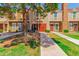 Inviting townhomes with lush landscaping, charming entryways, and mature shade trees along a sidewalk at 3416 W Julie Dr # 4, Phoenix, AZ 85027