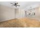 Open-concept living room featuring neutral colors, tiled floors, and ceiling fan at 3416 W Julie Dr # 4, Phoenix, AZ 85027