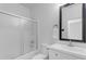 Bright bathroom features black framed mirror, sleek vanity, and bathtub with shower at 3535 W Morgan Ln, San Tan Valley, AZ 85144