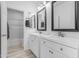 Bright bathroom features dual sinks, modern vanities, and a shower with glass doors at 3535 W Morgan Ln, San Tan Valley, AZ 85144