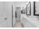 Bright bathroom features dual sinks, modern vanities, and a shower with glass doors at 3535 W Morgan Ln, San Tan Valley, AZ 85144