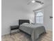 Bedroom with a queen bed, bedside table, and large arched window at 3535 W Morgan Ln, San Tan Valley, AZ 85144