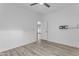 Empty bedroom features light wood floors, a ceiling fan and an exterior door at 3535 W Morgan Ln, San Tan Valley, AZ 85144