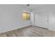Empty bedroom boasts light wood floors and a large window and closet at 3535 W Morgan Ln, San Tan Valley, AZ 85144