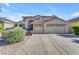 Two story home with large driveway and three car garage with a desert landscaped front yard at 3535 W Morgan Ln, San Tan Valley, AZ 85144