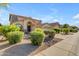 Two story home with large driveway and three car garage with a desert landscaped front yard at 3535 W Morgan Ln, San Tan Valley, AZ 85144