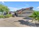 Two story home with large driveway and three car garage with a desert landscaped front yard at 3535 W Morgan Ln, San Tan Valley, AZ 85144