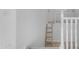 Bright upstairs hallway featuring white banisters and a decorative wooden ladder at 3535 W Morgan Ln, San Tan Valley, AZ 85144