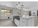 Open kitchen with a large island, pendant lighting, stainless steel appliances, and a farmhouse sink at 3535 W Morgan Ln, San Tan Valley, AZ 85144