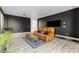 Cozy living room featuring dark walls, vinyl flooring, and a ceiling fan at 3535 W Morgan Ln, San Tan Valley, AZ 85144