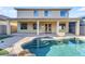 Backyard pool with tanning deck steps and exterior view of a two-story home with covered patio at 3535 W Morgan Ln, San Tan Valley, AZ 85144