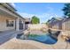 Backyard pool featuring rock waterfall, set within a stone-paved patio and block wall perimeter at 3535 W Morgan Ln, San Tan Valley, AZ 85144