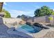 Backyard pool featuring rock waterfall, set within a stone-paved patio and block wall perimeter at 3535 W Morgan Ln, San Tan Valley, AZ 85144