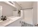Bright bathroom with black and white patterned floors, white vanity with large mirror, and shower with curtain at 3555 E Morenci Rd, San Tan Valley, AZ 85143