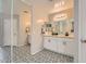 Bathroom with double sink vanity, decorative mirrors, and black and white tiled floors at 3555 E Morenci Rd, San Tan Valley, AZ 85143