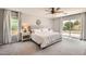 Bright bedroom with a ceiling fan, slider, white walls, and neutral carpet at 3555 E Morenci Rd, San Tan Valley, AZ 85143