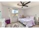 Cozy bedroom with a white metal frame bed, colorful bedding, and a dresser at 3555 E Morenci Rd, San Tan Valley, AZ 85143