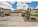 Inviting two-story home featuring a three-car garage and desert landscaping at 3555 E Morenci Rd, San Tan Valley, AZ 85143