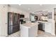 Well-lit kitchen with white cabinets, stainless steel appliances, and an island at 3555 E Morenci Rd, San Tan Valley, AZ 85143